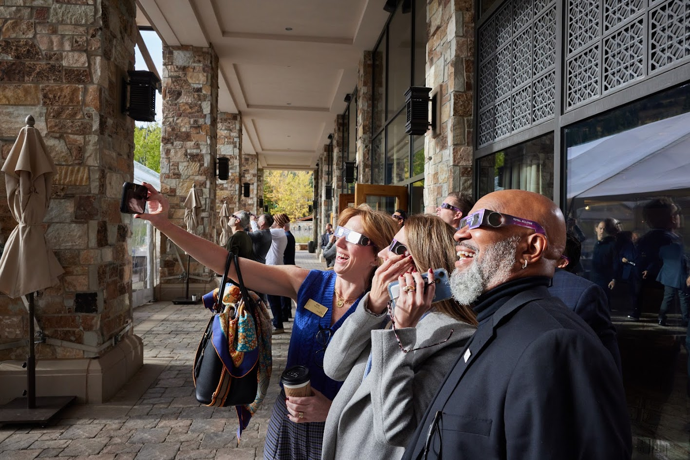 Guests taking an eclipse selfie outdoors