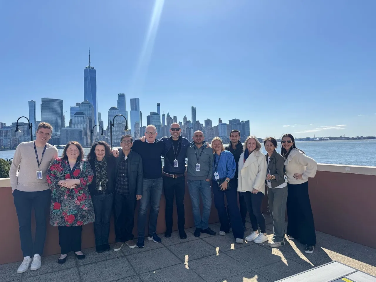 Team rooftop group photo with skyline