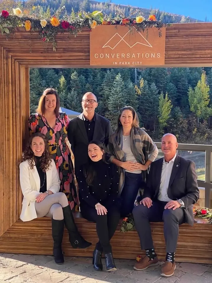 Group portrait inside Conversations in Park City wood frame