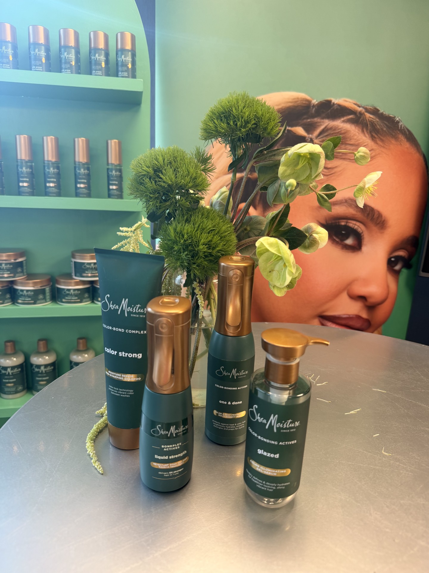 SheaMoisture color-bond product display with greenery