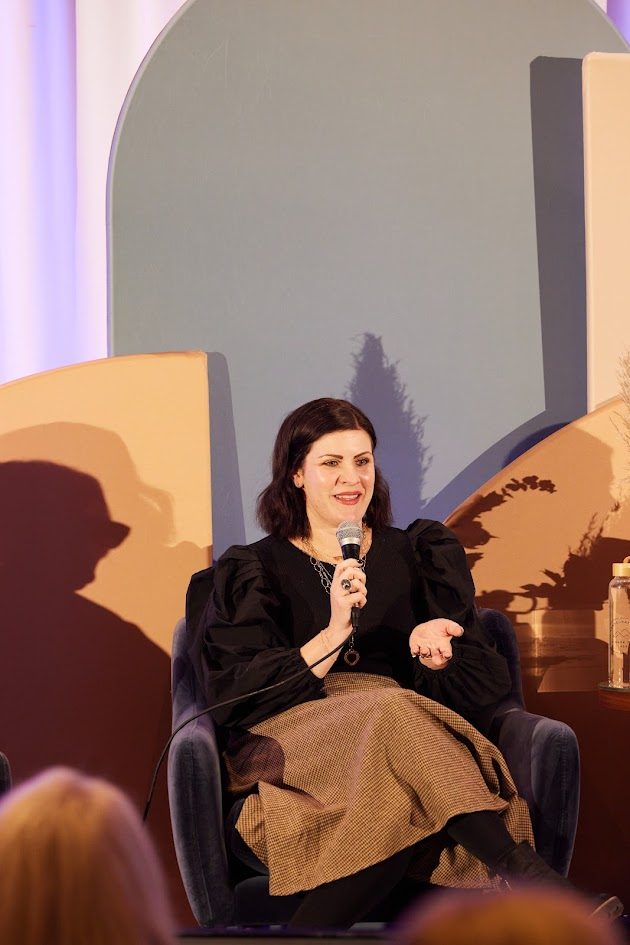 Speaker seated on stage