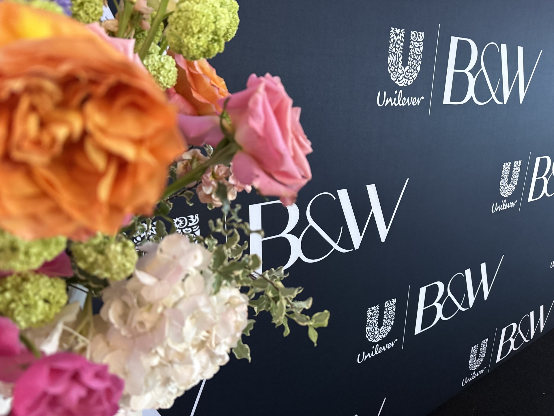 Unilever and B&W step and repeat with spring florals